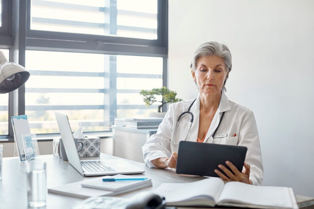 Doctor reviews documents on tablet